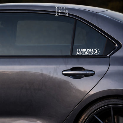 Weißer THY Sticker auf der hinteren Seitenscheibe eines grauen Autos